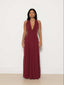 Woman wearing a burgundy evening gown against a white background